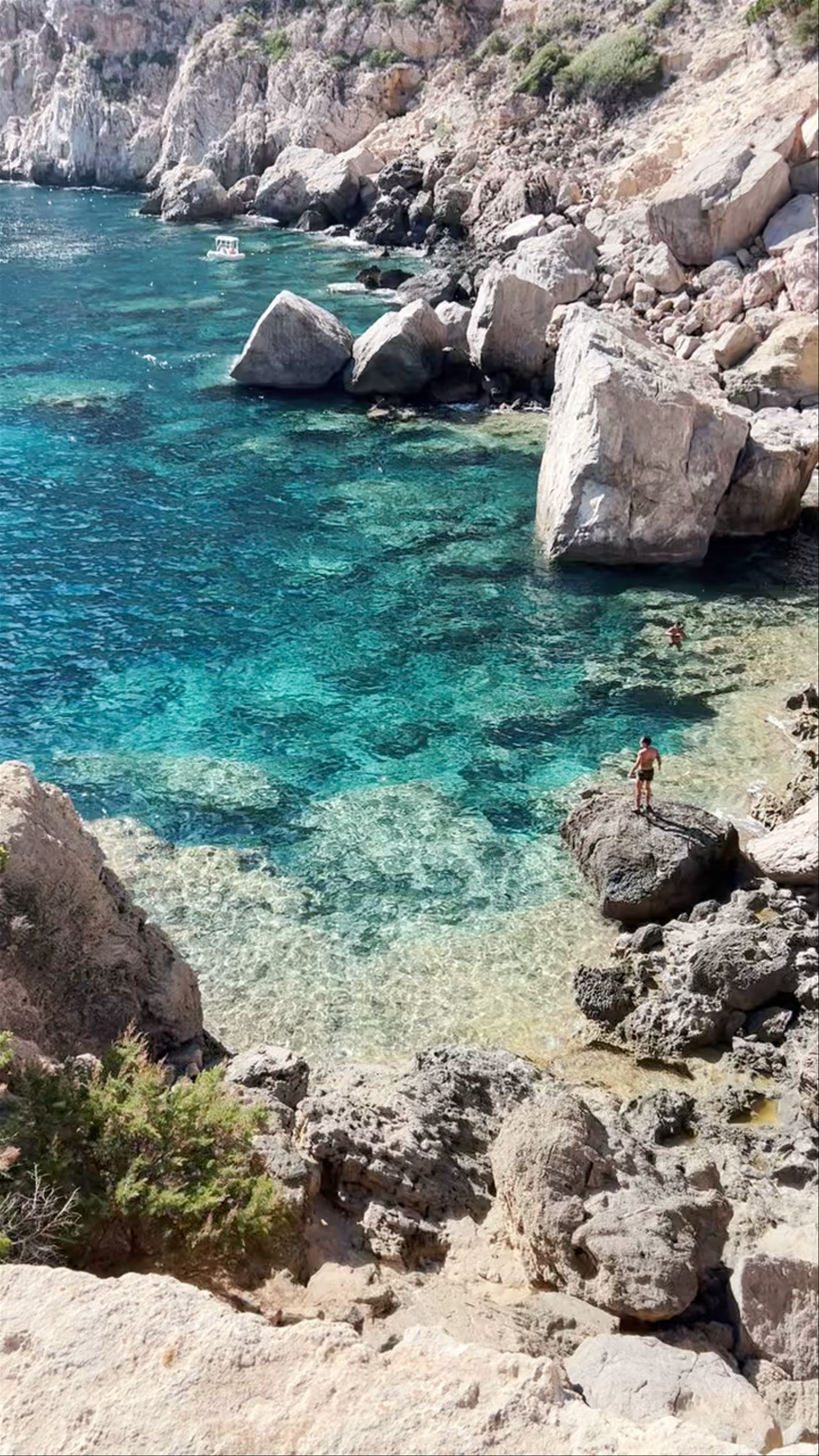 Crystal Waters and Rugged Cliffs at Cala d’Hort, Spain