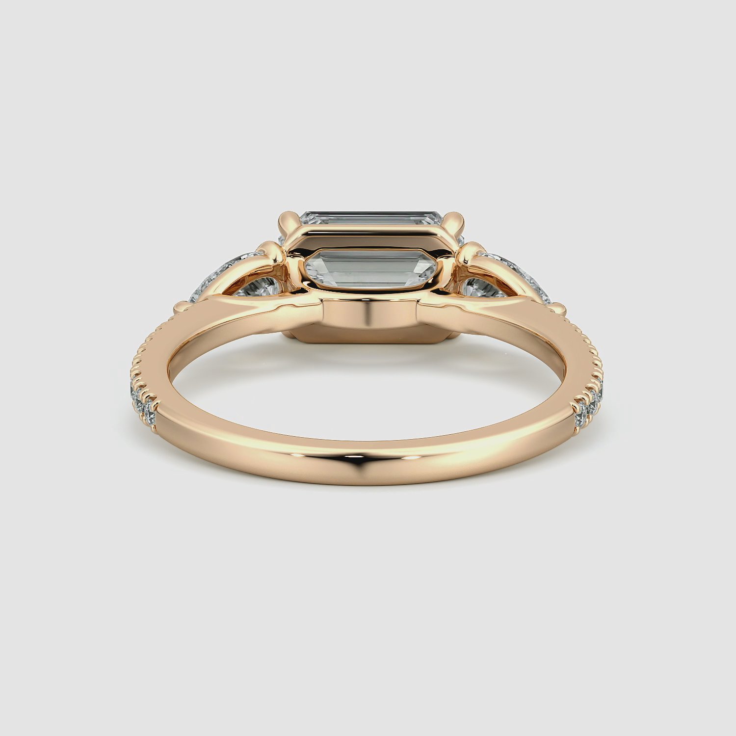 The Three Stone | Emerald | 14k | Rose Gold | bandAccent: Pavé | diamondOrientation: horizontal | sideStoneCarat: 0.25ct | sideStoneShape: Pear | caratWeight: other