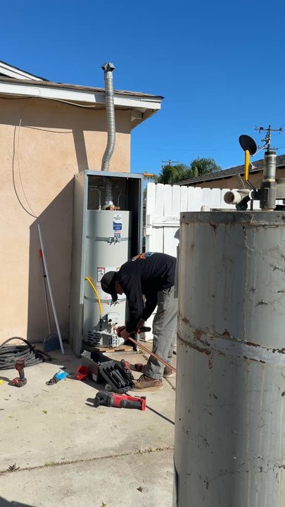 Prime Plumbing Experts - Jonny working on installing the new water heater and pipes - Plumbing Near Me