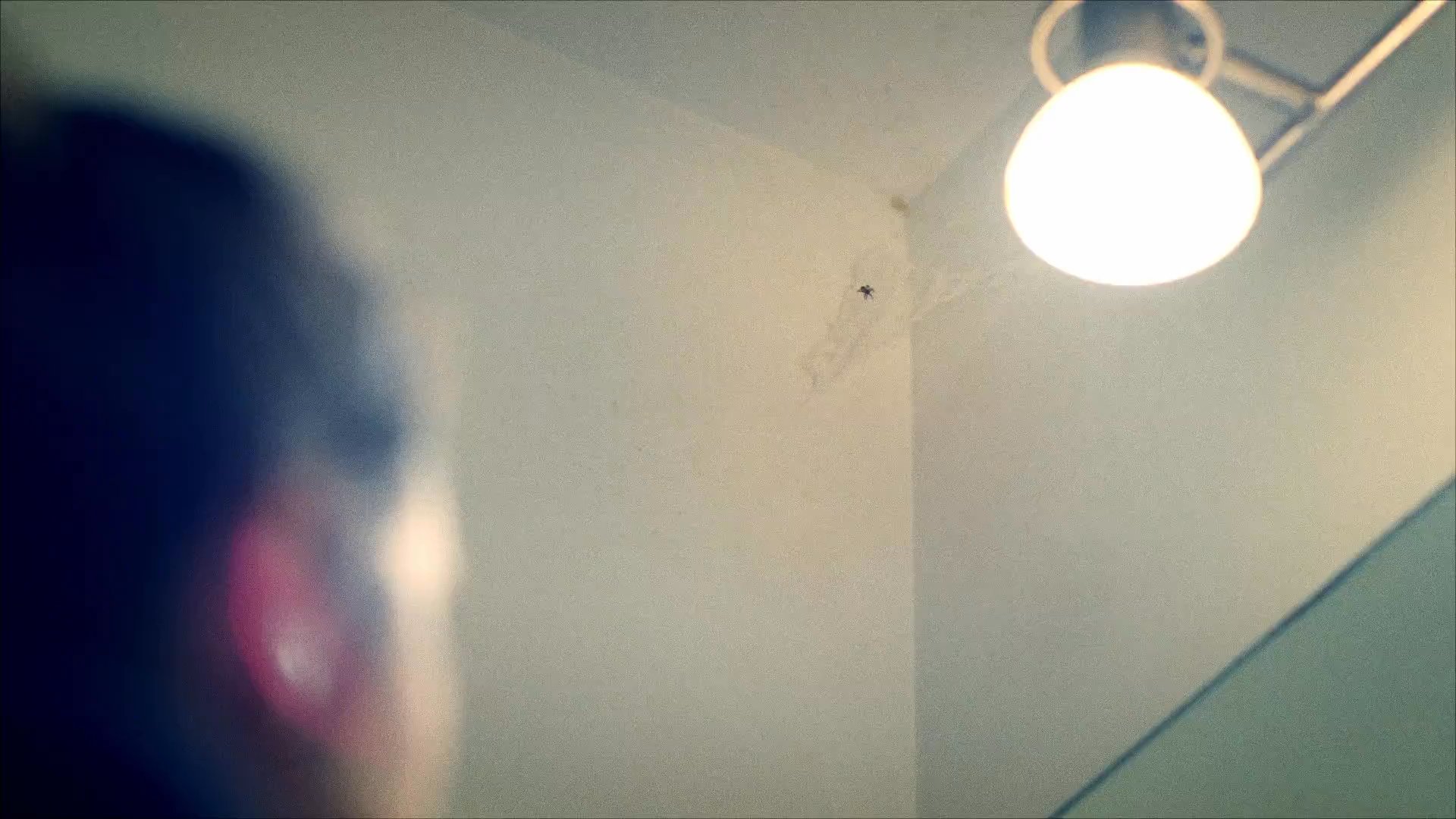 A woman observes her reflection in a bathroom mirror before experiencing a sudden onset of emotional distress and physical unease.