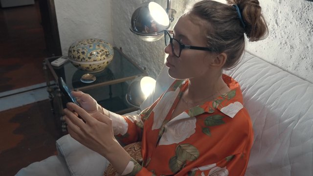 A girl browses the online NFT marketplace on her smartphone