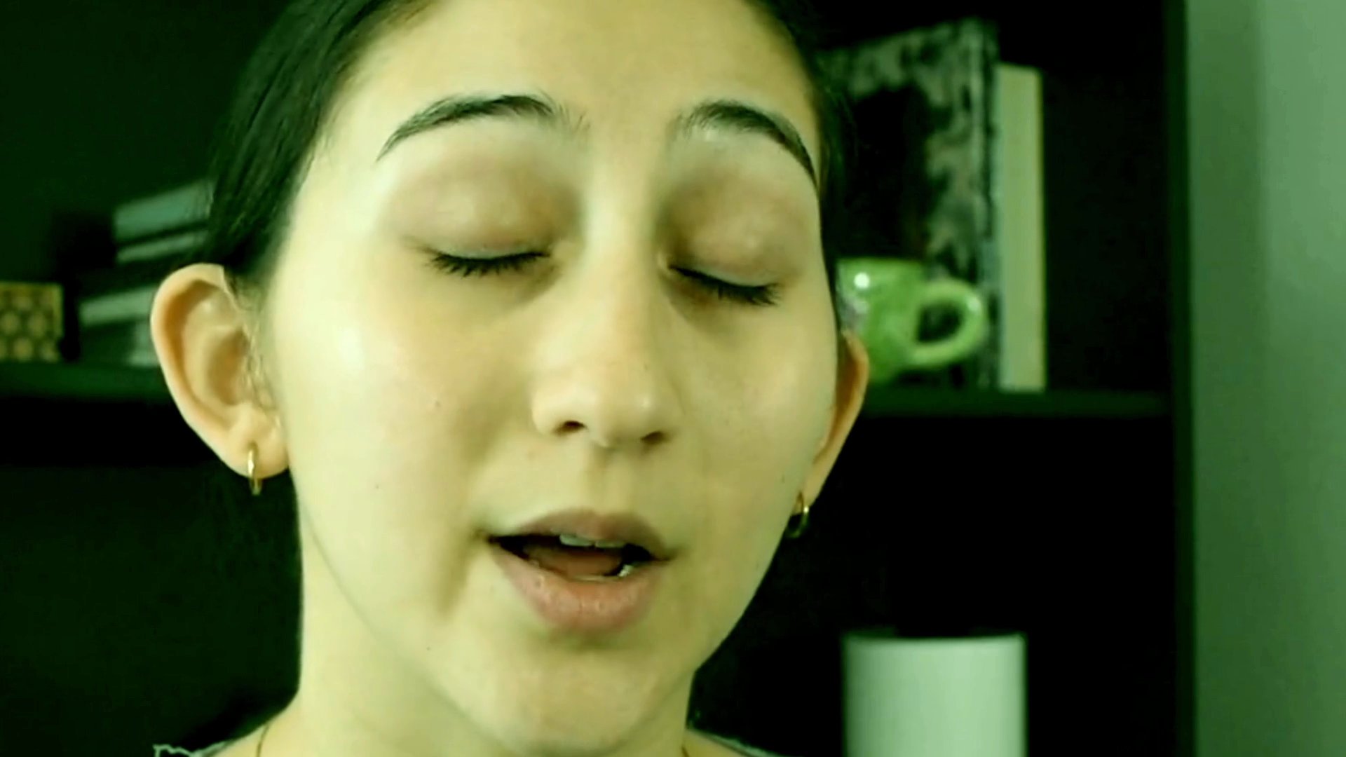 A woman speaks directly to the camera in a series of shots, punctuated by a brief appearance from a man in the final frames.