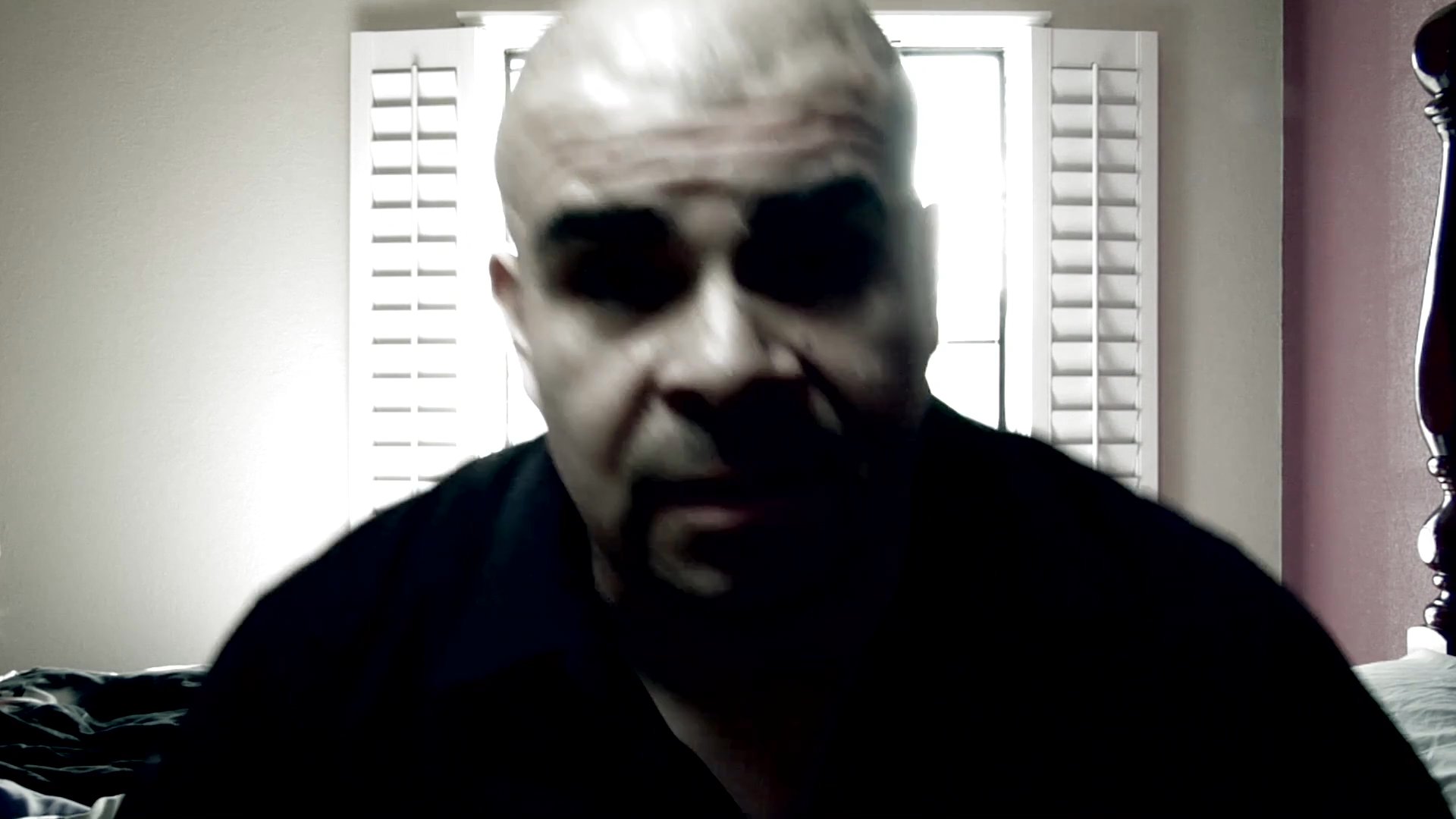 A man speaks directly to the camera while positioned in a room, transitioning to an aerial perspective of a residential home and a person standing in the yard.