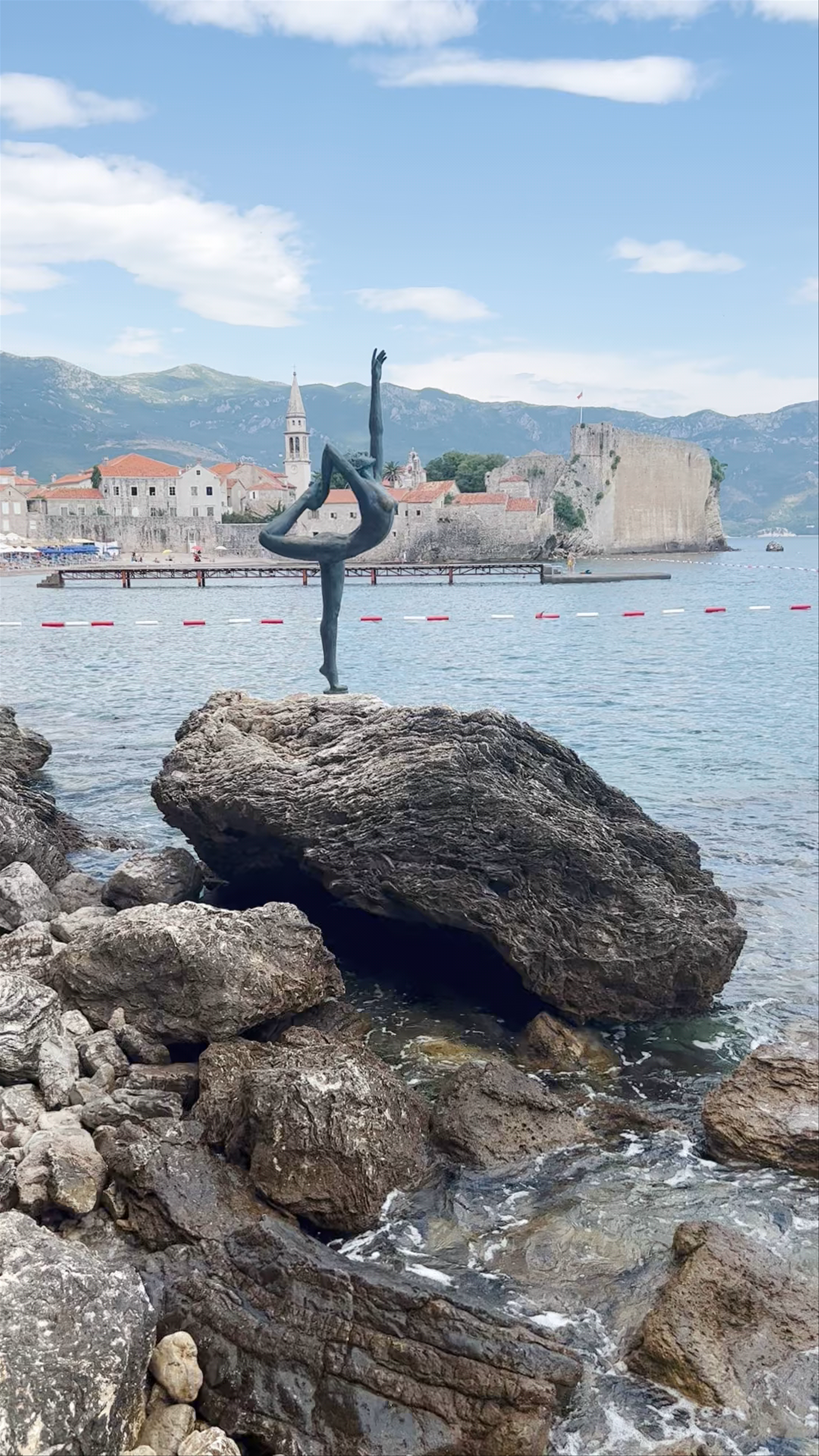 Ballerina Statue at Beach Greco with Old Town Budva Backdrop