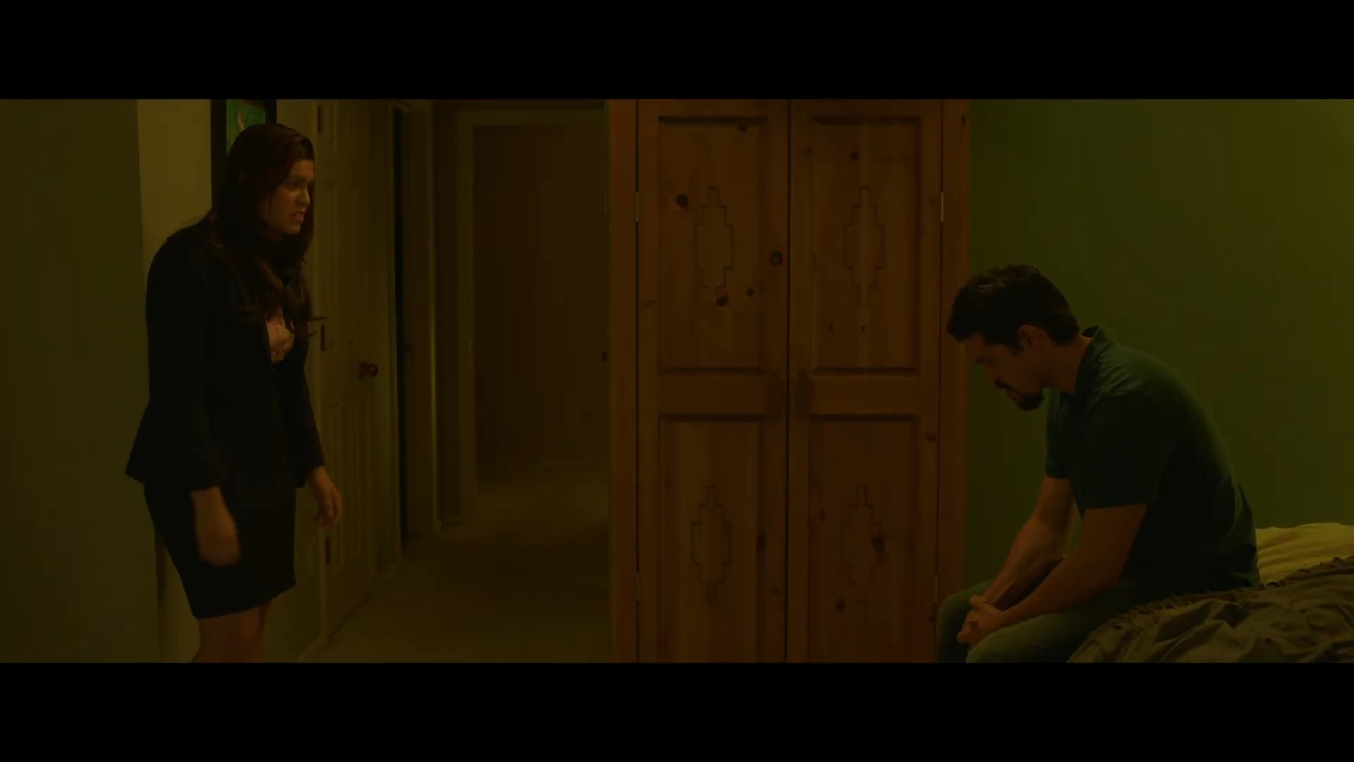 A woman confronts a seated man in a tense, emotionally charged exchange. Following their disagreement, a subsequent scene depicts a woman and a child sitting together on a couch a month later.