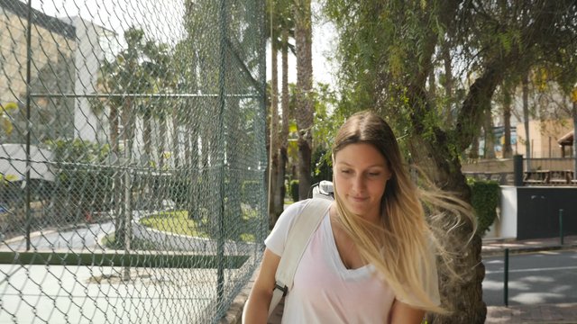 Woman entering the tennis court