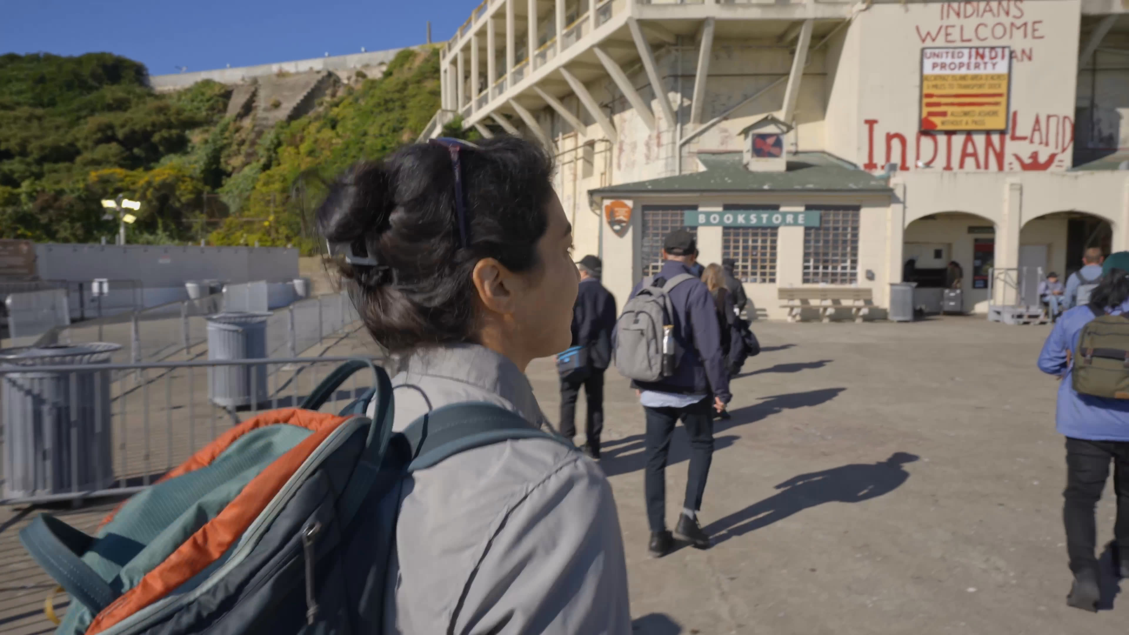 A visitor arrives by ferry and walks past Alcatraz’s historic buildings toward rocky shorelines crowded with nesting birds. The island’s unexpectedly large bird colonies contrast with its better-known prison history.