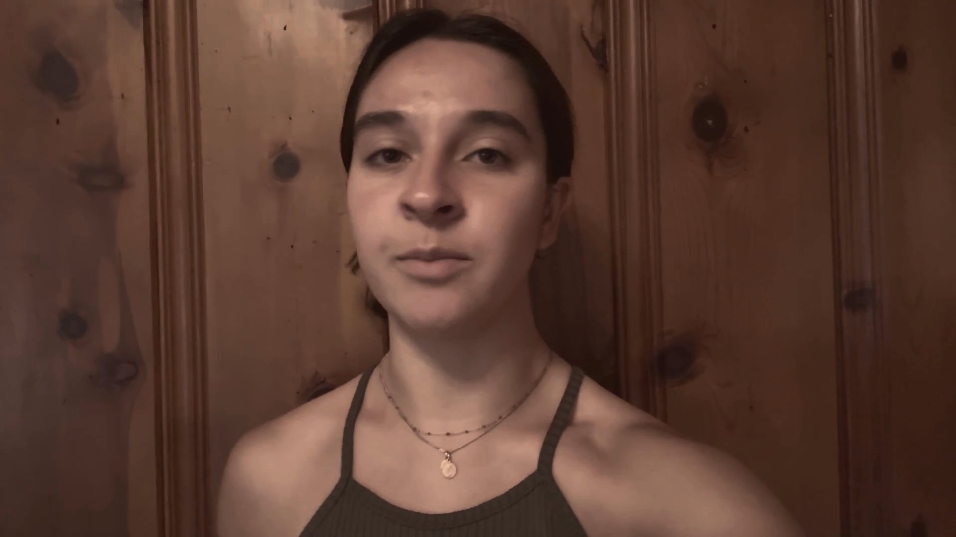 A young woman performs a dramatic monologue against a wooden paneled background, displaying a range of intense facial expressions and vocal intensity.