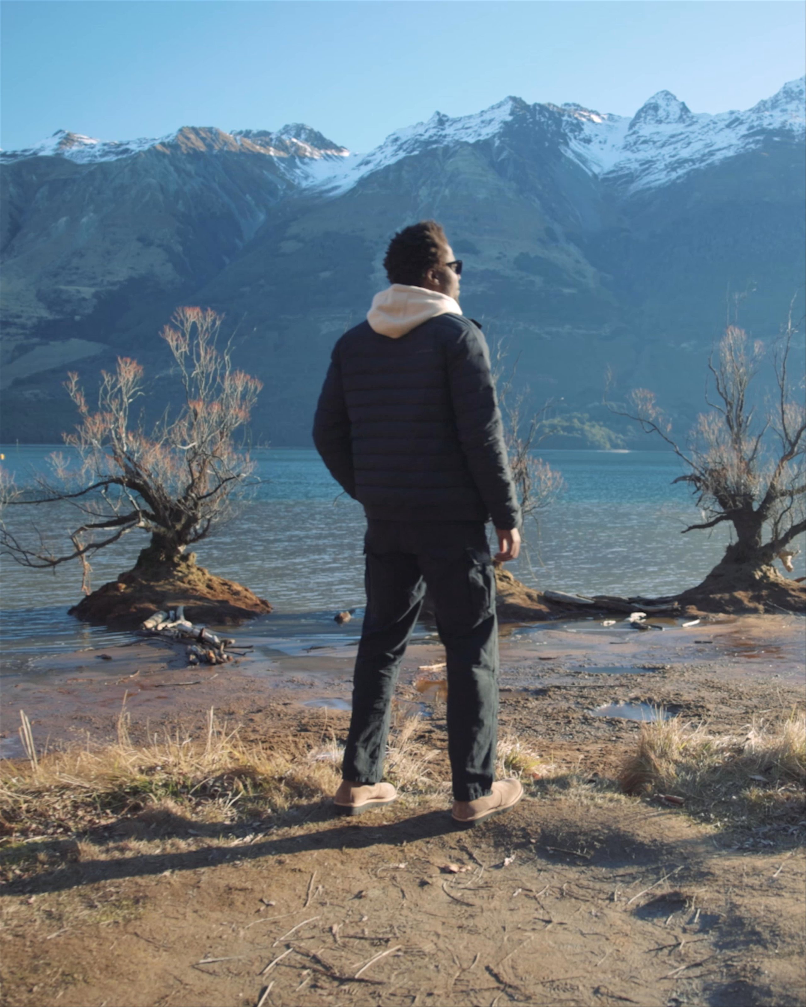 Video of man wearing the Launch Jacket standing alongside river in New Zealand