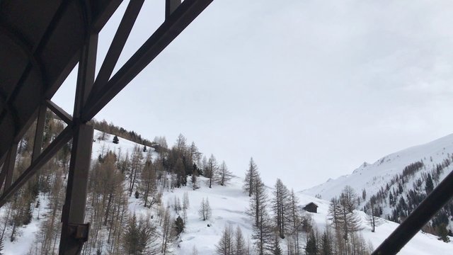 A train surrounded by snow, enters a tunnel