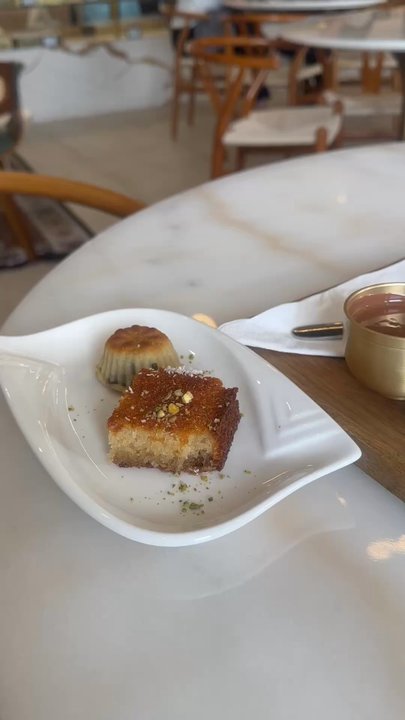 Taj A Sweet Cafe - Delicious desserts. Basbusa, mahmoul, and San Sebastián/Basque Cheesecake with chocolate sauce. - Themed Cafes Near Me - Houston, Texas
