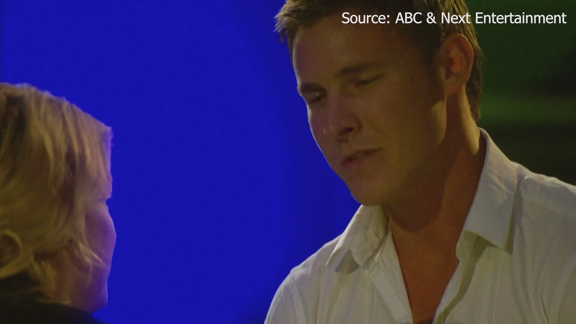 Kasey, an advertising account executive, shares a conversation with his date on a reality television program. He expresses his reluctance to repeat a past romantic gesture while sitting in a dim, intimate outdoor setting.