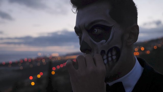 Man with Halloween makeup smoking