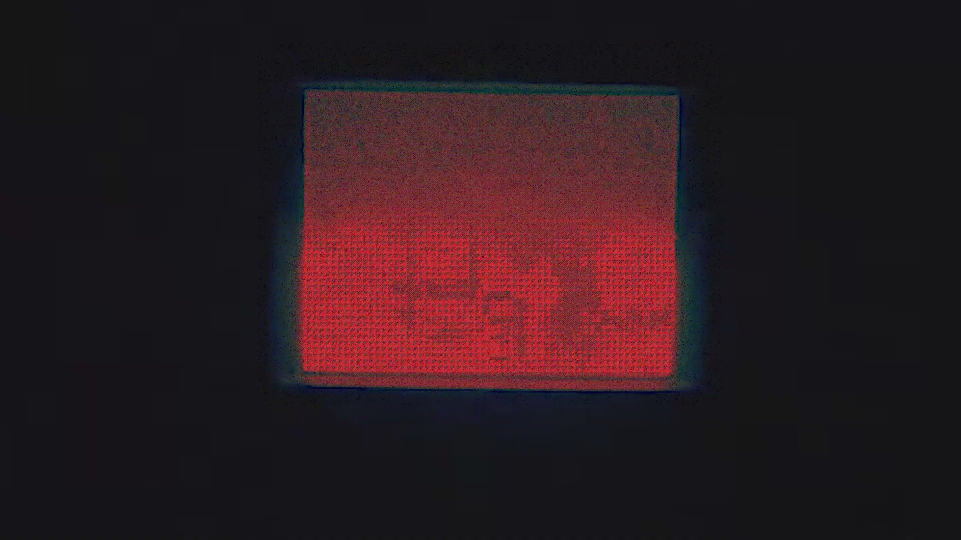Multiple monitors display a synchronized landscape feed through red-toned thermal imaging technology, while dark silhouettes observe the output in the foreground.
