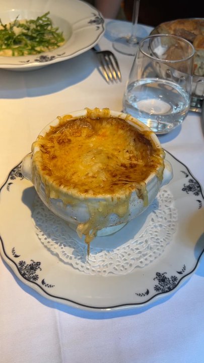 Le Procope - Taking that first scoop of the French Onion Soup. Thick, cheesy and bready. - French Near Me - Paris, 75