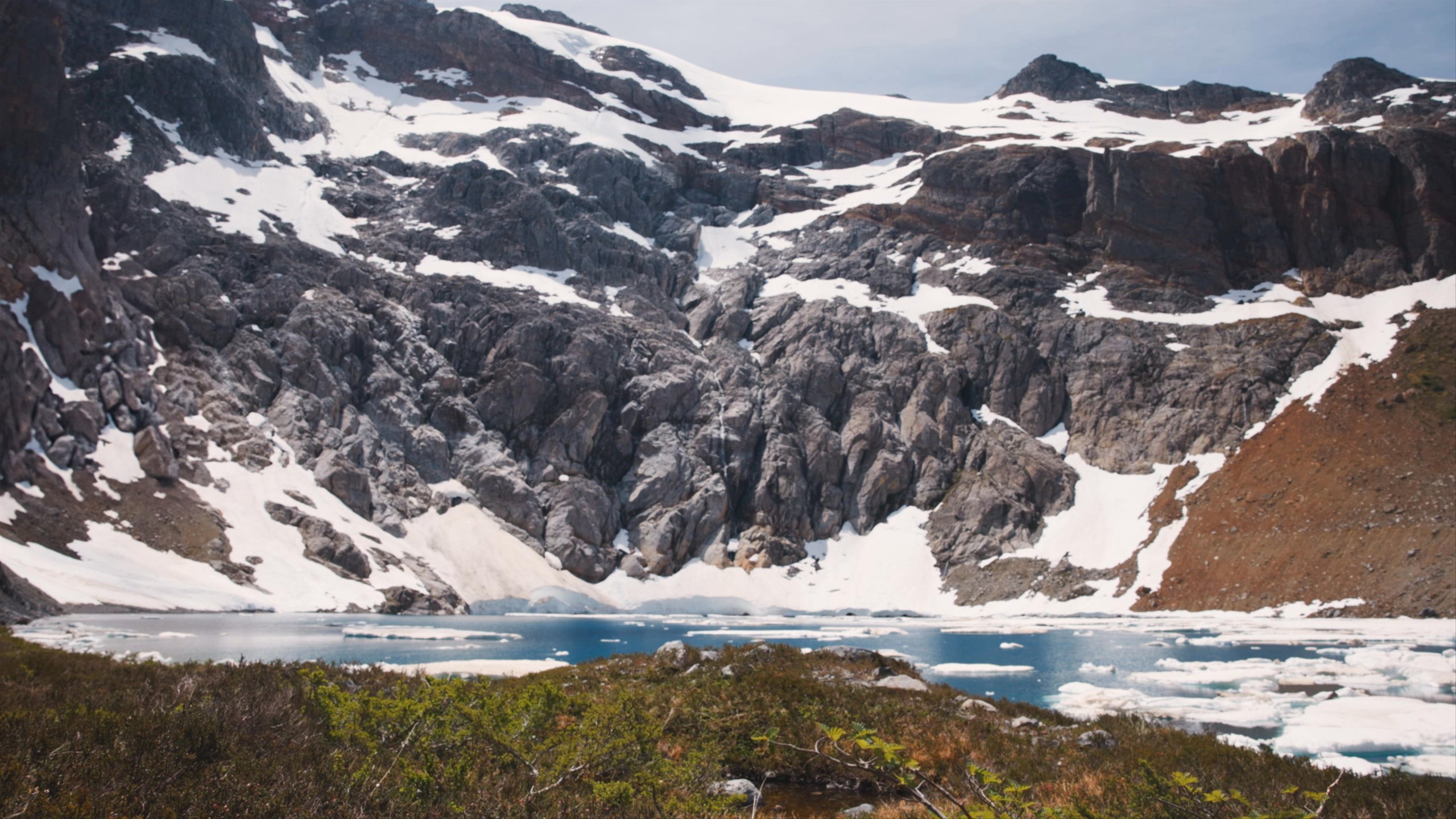 Woman walking along icy lake in Patagonia