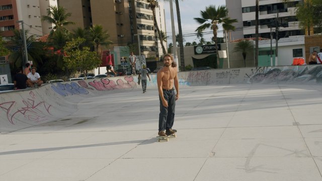 Topless man skateboarding