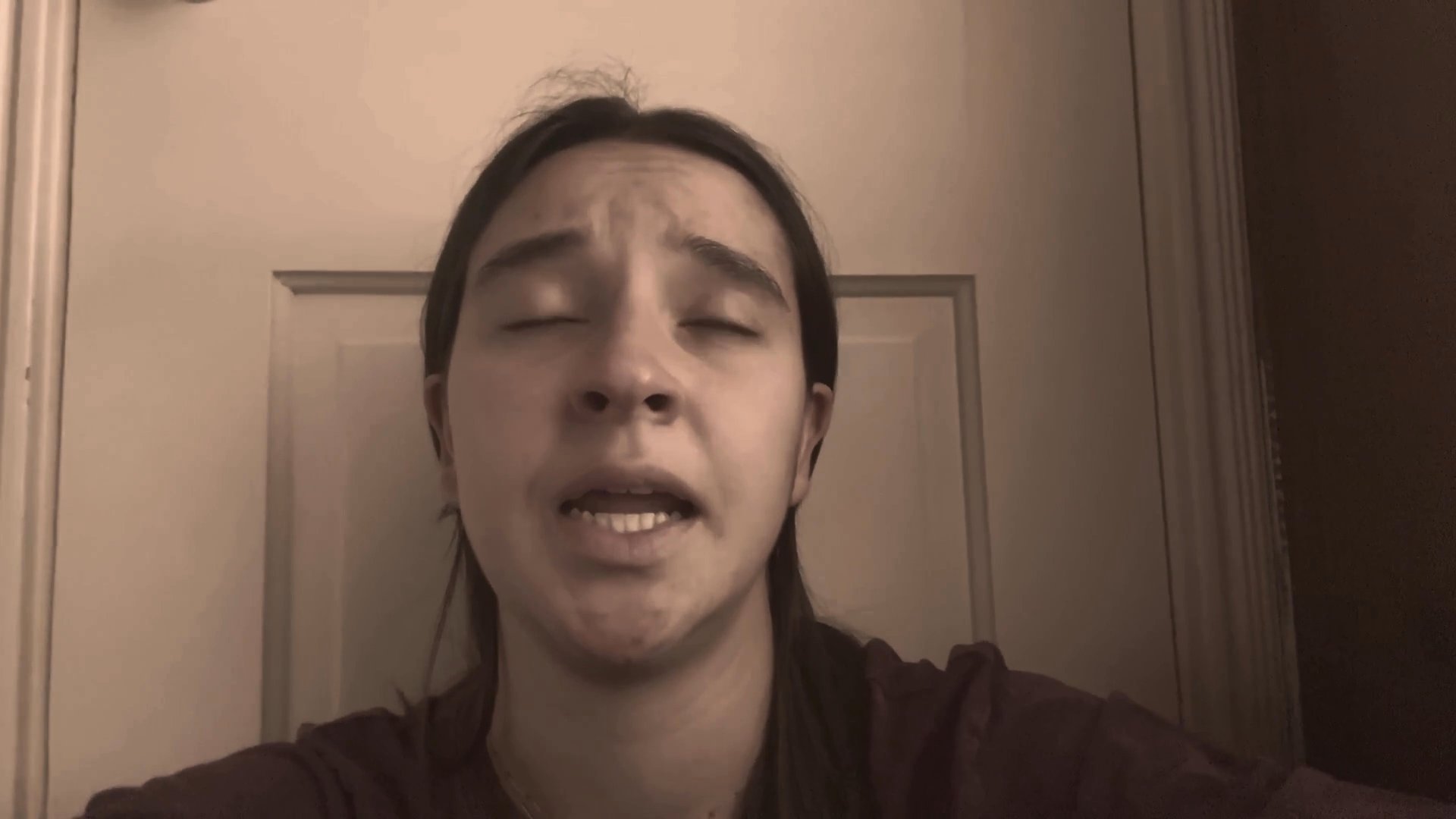 A young woman speaks directly to the camera, sharing personal insights through a sequence of varied facial expressions and verbal delivery.