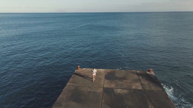 Man running on the deck near the ocean 
