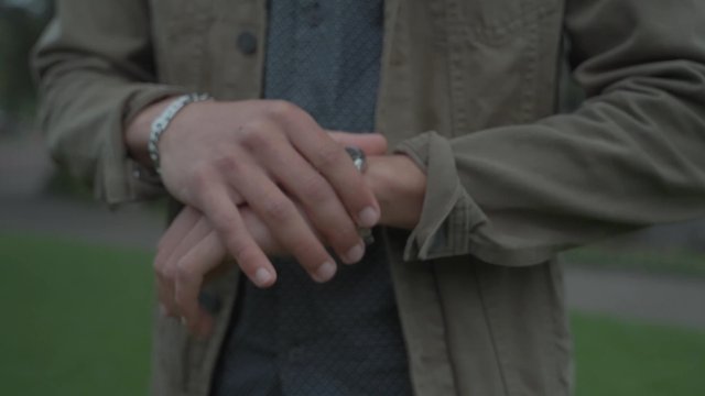 A guy adjusting his wristwatch