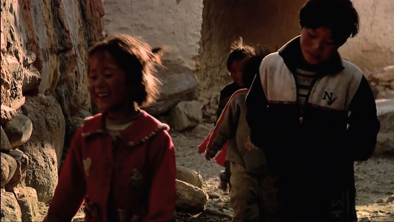 Visitors engage with residents in a remote Tibetan village before a light aircraft departs from the mountainous region.