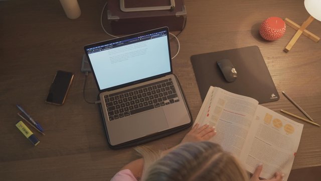 A student flipping through pages of a marketing book