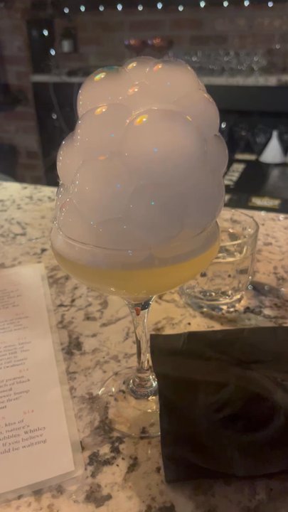 Gruene’s Last Call - Seasonal Drink but forgot the name.. It was Gin! Don't pop the bubbles and drink the drink because they are flavored. - Cocktail Bars Near Me - New Braunfels, Texas