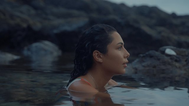 A beautiful girl standing neck-deep in the sea