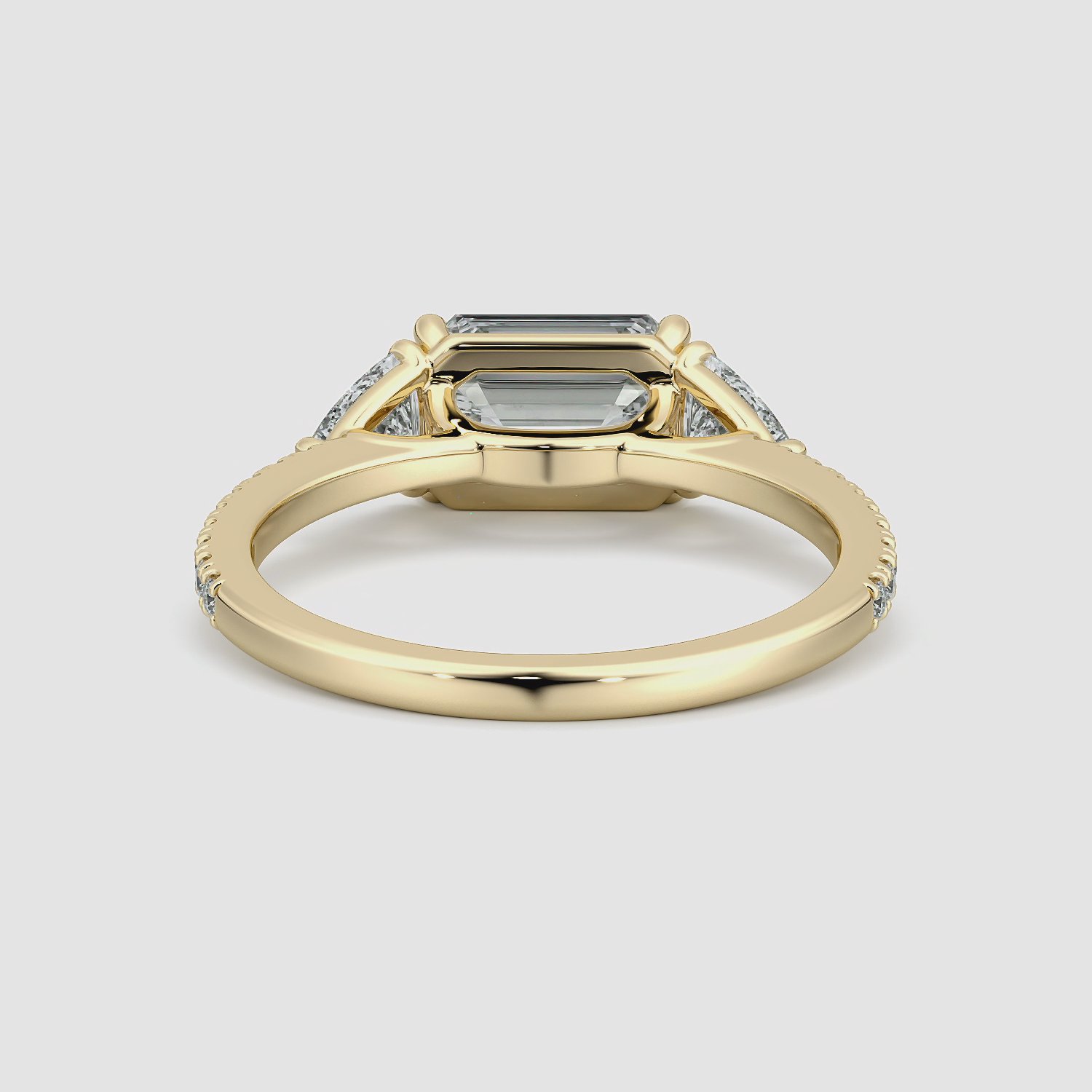 The Three Stone | Emerald | 18k | Yellow Gold | bandAccent: Pavé | diamondOrientation: horizontal | sideStoneCarat: 0.25ct | sideStoneShape: Trillion | caratWeight: other