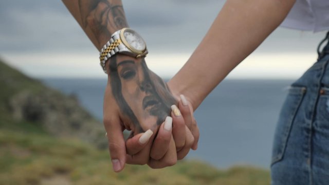 Close-up of a couple holding hands