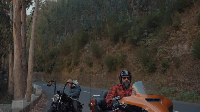 A motorcyclist waiting for his friend to get ready