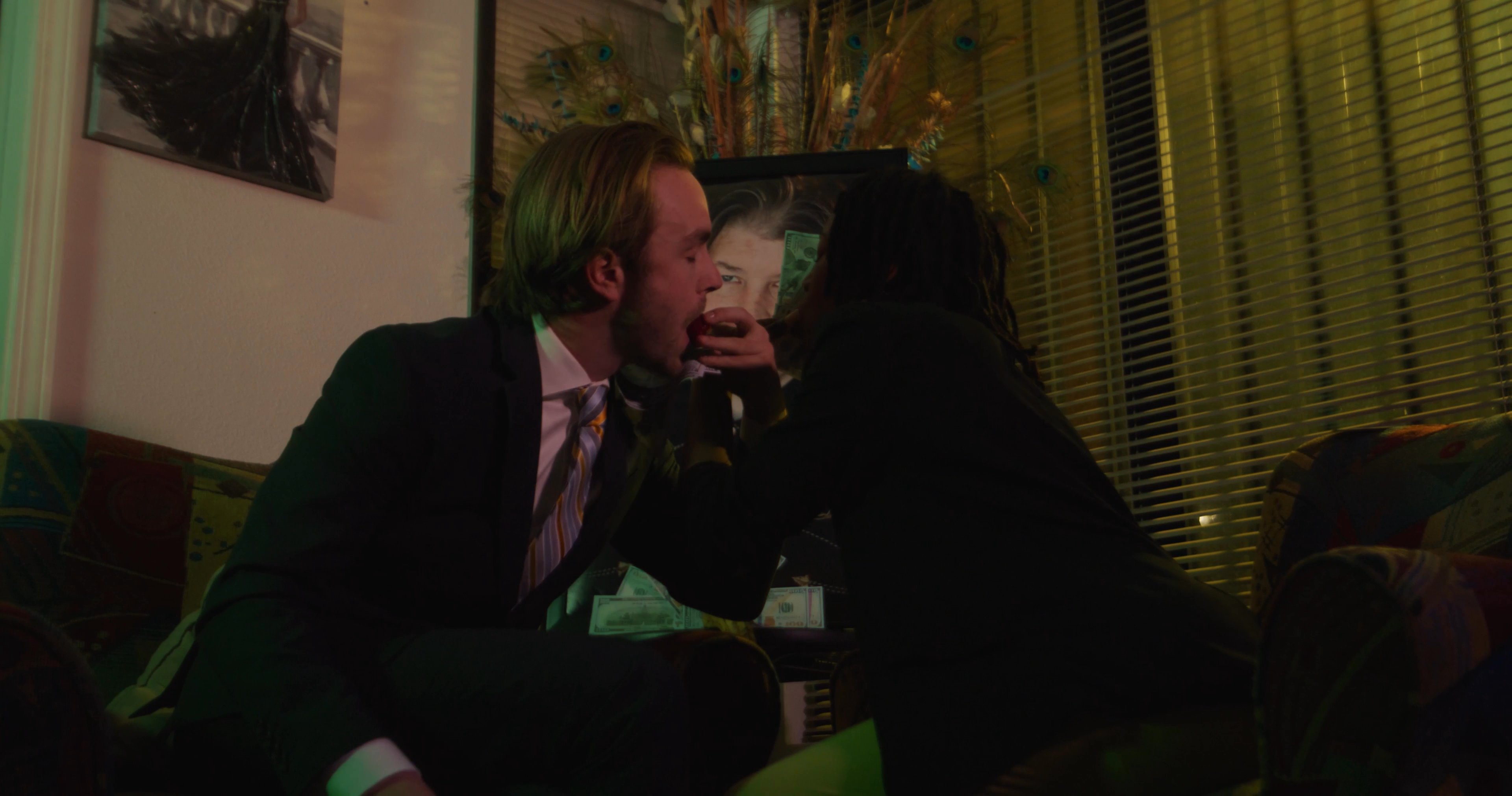 Individuals engage in a tense financial exchange within a residential setting, marked by emotional volatility and shifting interpersonal dynamics.