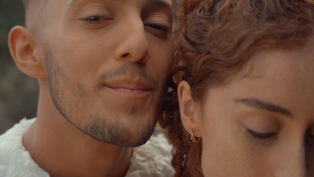 A man singing into his girlfriend's ear