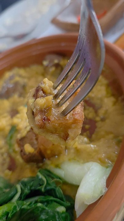 Pinoy Kitchen - A video clip of a fork holding a piece of the deep fried skin-on pork belly. - Filipino Near Me - Vinton, Virginia