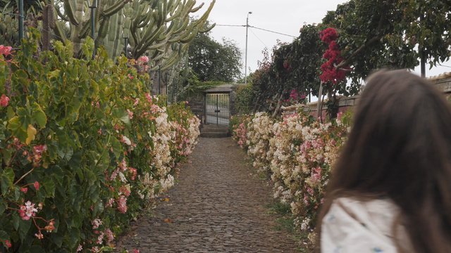 Woman running near a flower garden 