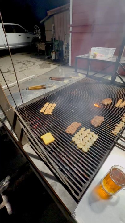 Olde Towne - Everyone gathered around the grill cooking their food - Bars Near Me - Ripon, California