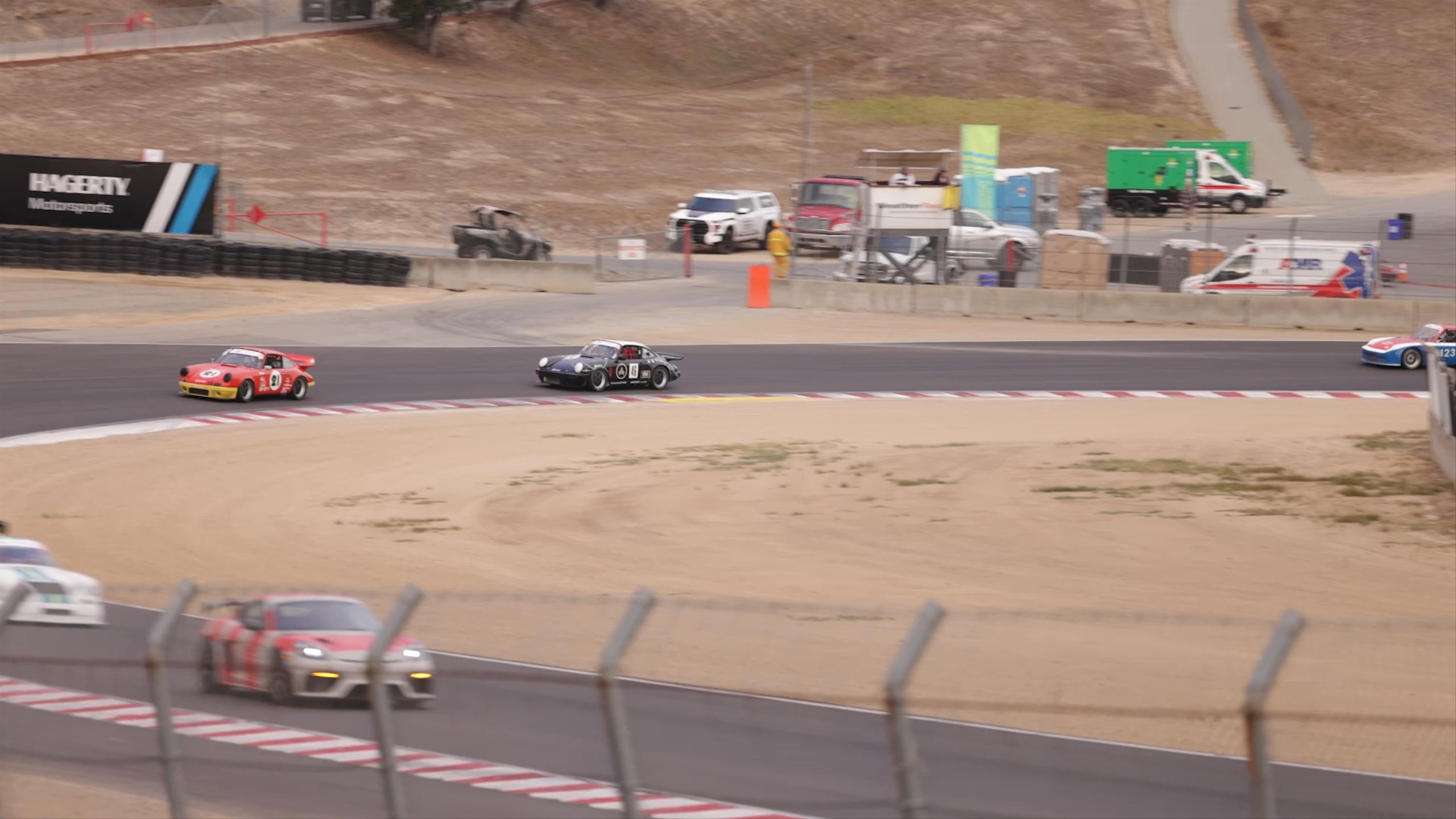 Vintage Porsche cars driving on Rennsport track