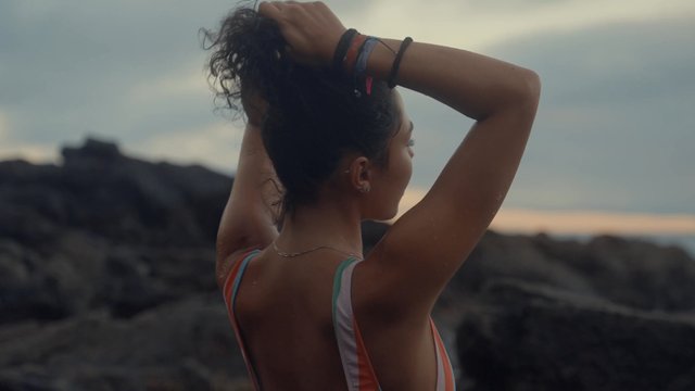 A girl tying her hair up
