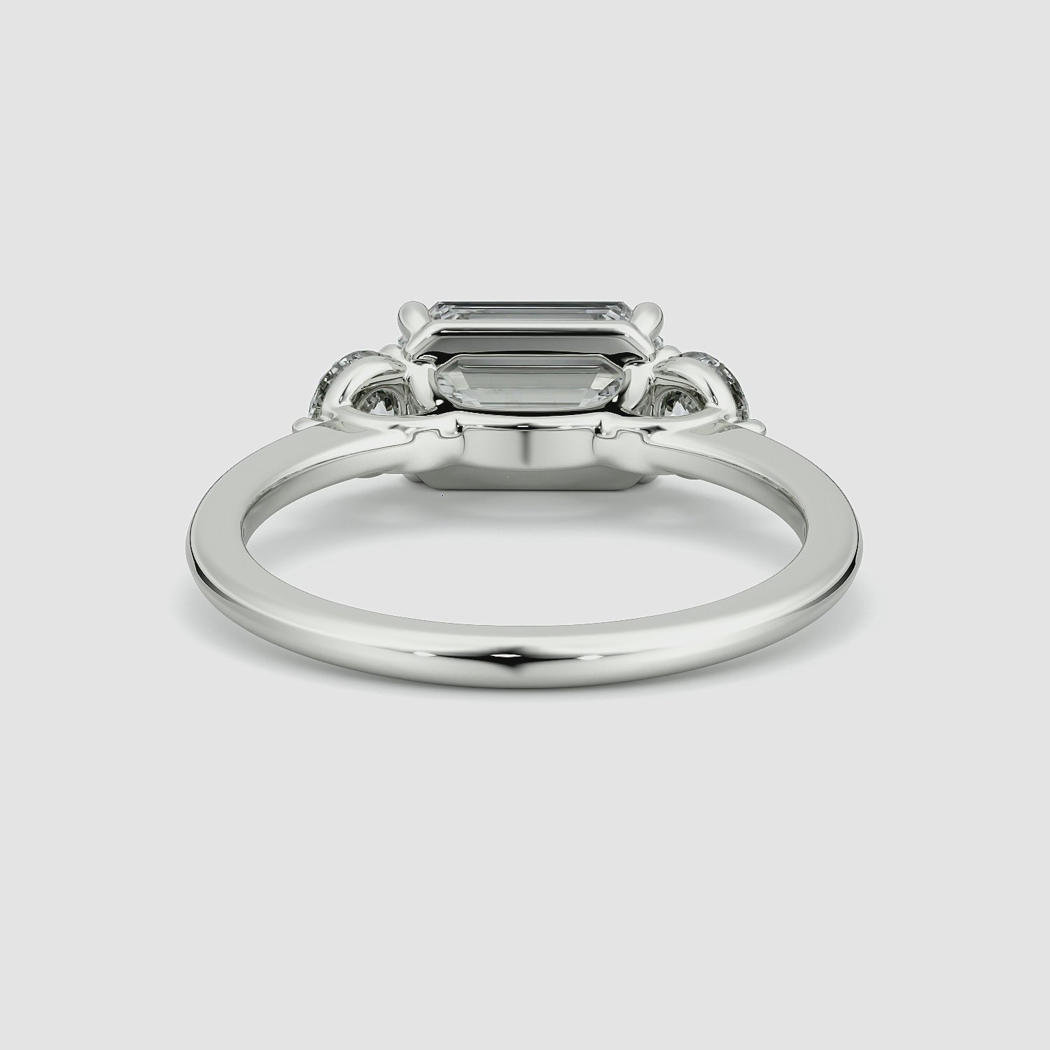 The Three Stone | Emerald | Platinum | bandAccent: Plain | diamondOrientation: horizontal | sideStoneCarat: 0.25ct | sideStoneShape: Round Brilliant | caratWeight: other