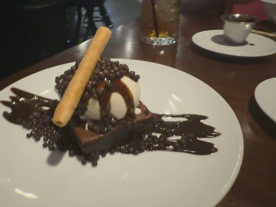Modern Corner Grill - Brownie dessert with chocolate sauce and chocolate pearls for topping - Steakhouses Near Me - Scottsdale, Arizona
