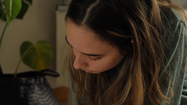 Girl writing "I love you so much" on a poster