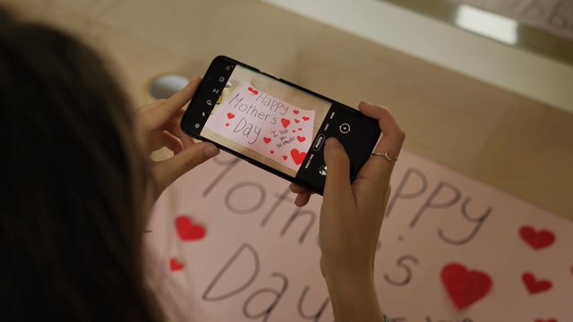 Taking photos of a Mother's Day poster with a smartphone