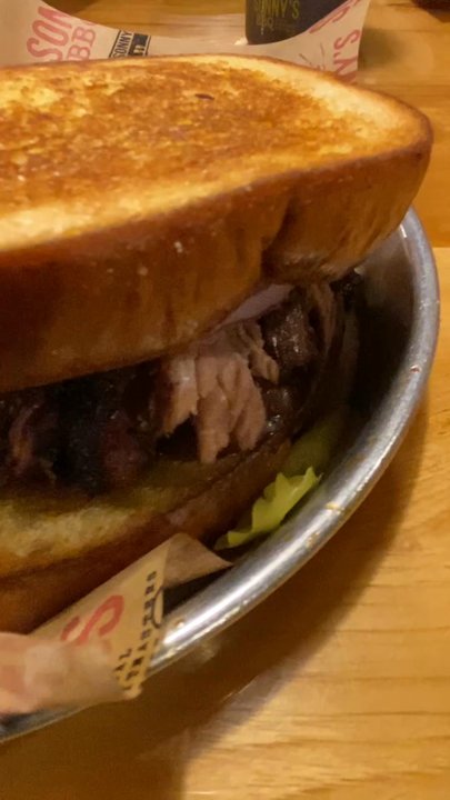 Sonny's BBQ - SMOKIN' GUN  (Sandwich) Jalapeno Cheddar Sausage, Chopped Brisket, banana peppers, red onion, Mustard and Sweet BBQ Sauce on Garlic Bread - Barbeque Near Me - Largo, Florida