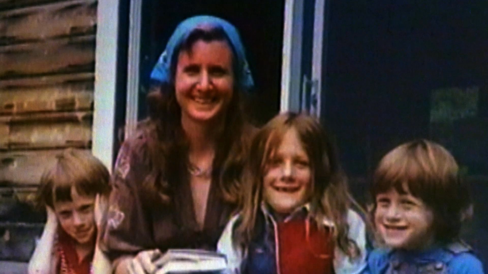 Handwritten text transitions into home video footage of a mother and her children, followed by a tribute sequence featuring Bill Graham at a live music event.