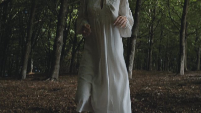 Woman runs through a forest