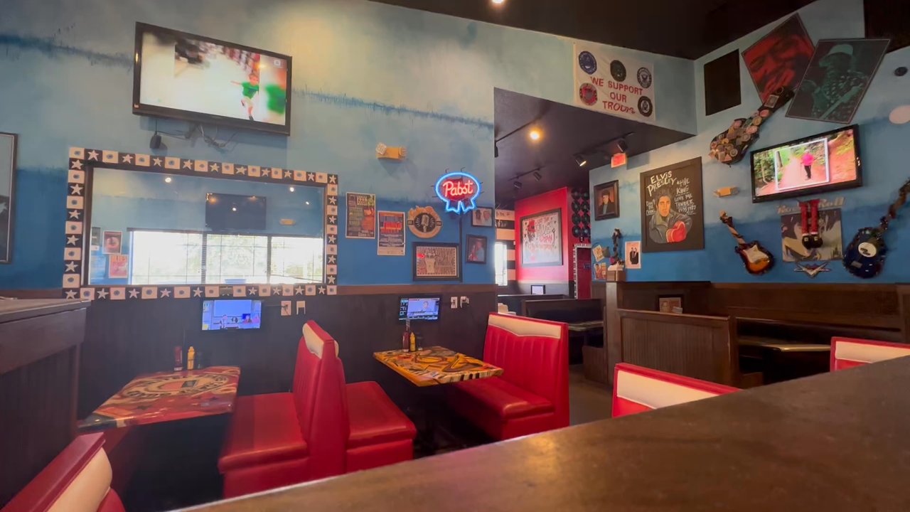 The Mojo Grill & Catering - TV's even in the booths.   I've never seen that before.  A true local yocal place - American Near Me - Belleview, Florida