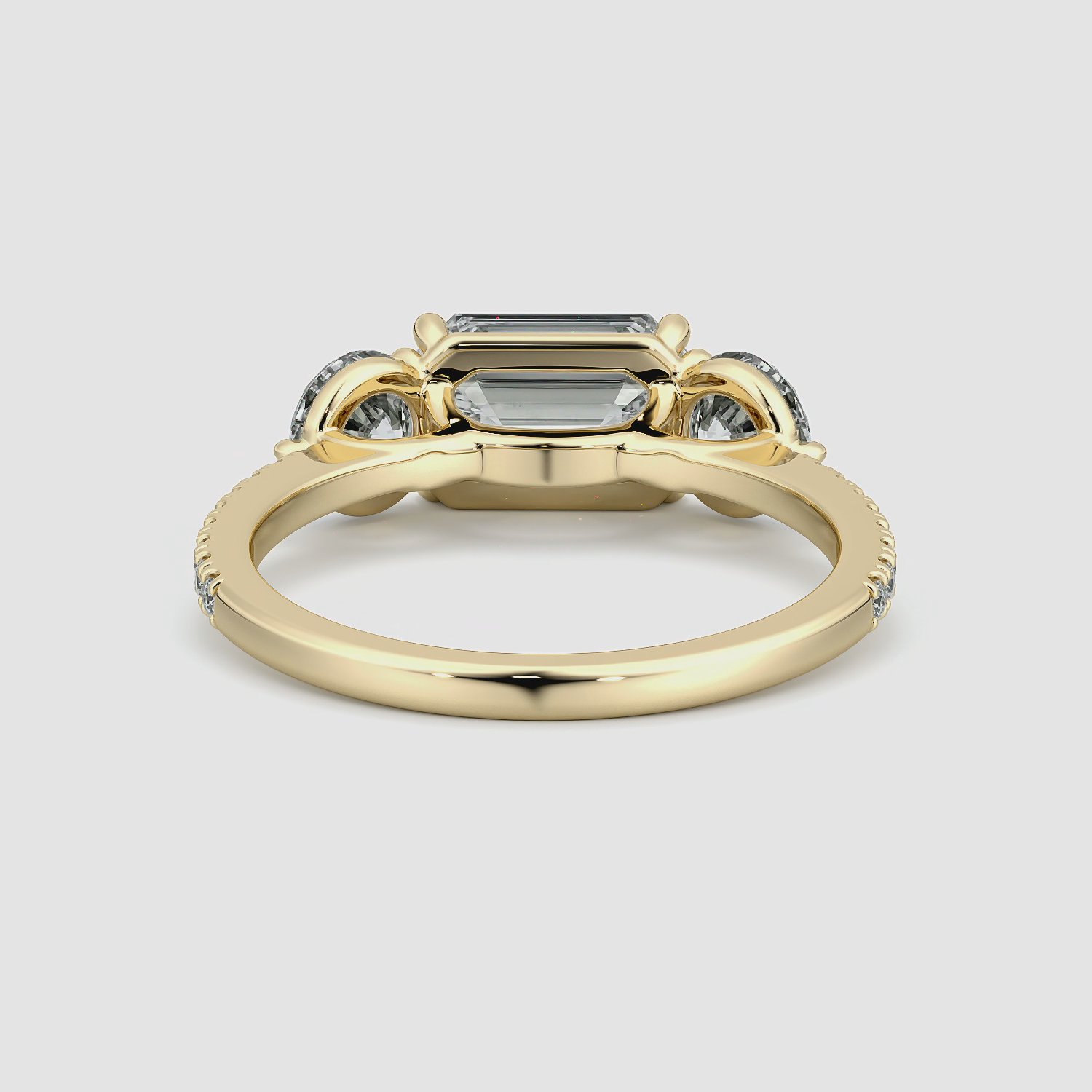 The Three Stone | Emerald | 18k | Yellow Gold | bandAccent: Pavé | diamondOrientation: horizontal | sideStoneCarat: 0.50ct | sideStoneShape: Round Brilliant | caratWeight: other