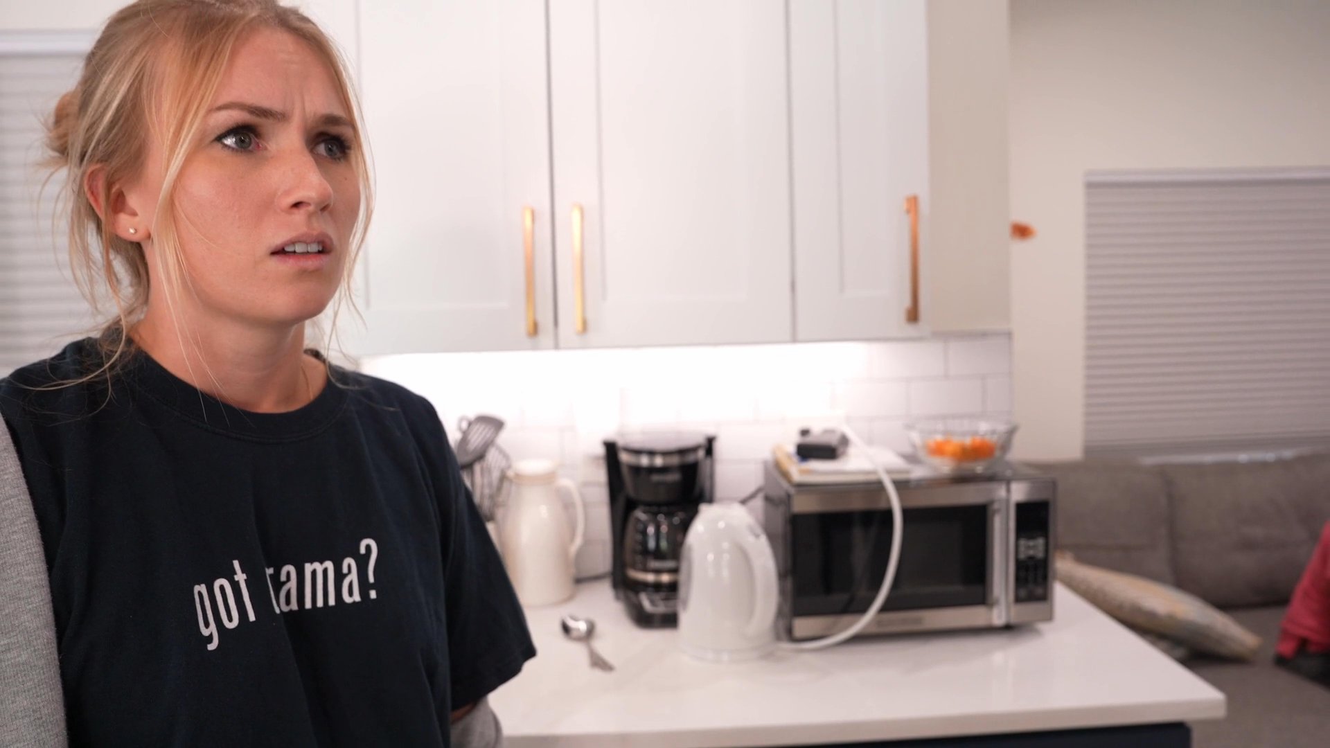 A tense domestic argument unfolds in a kitchen setting, leading to emotional distress among family members. The scene captures a moment of interpersonal conflict and reactive dialogue.