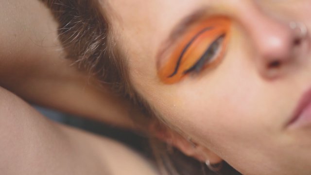 Woman with orange eye makeup 