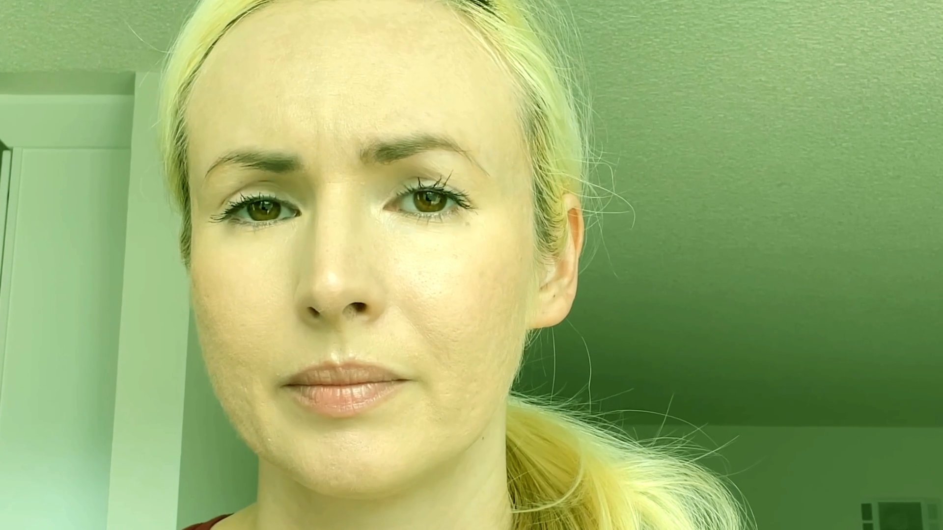 A woman with blonde hair addresses the audience directly, conveying information through measured facial expressions and speech. She maintains a consistent, focused presence throughout the segment.